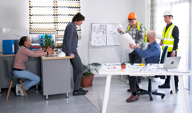Office team reviewing construction plans