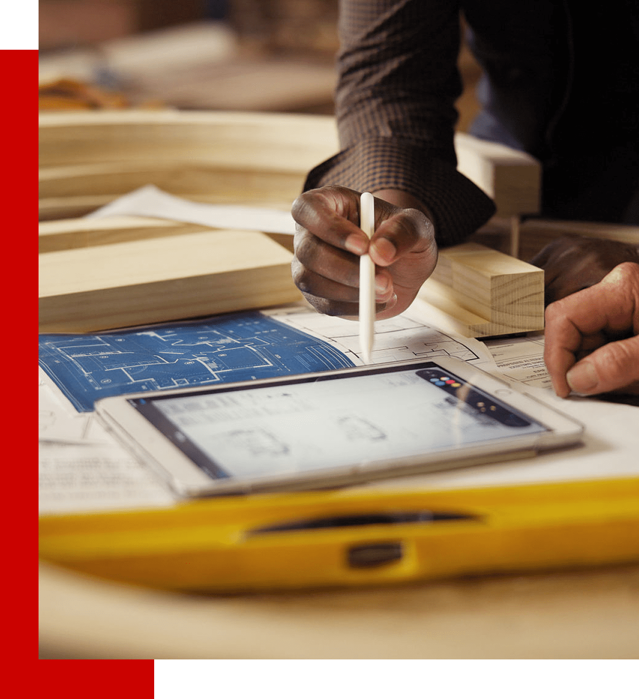 Tablet and blueprint on a desk